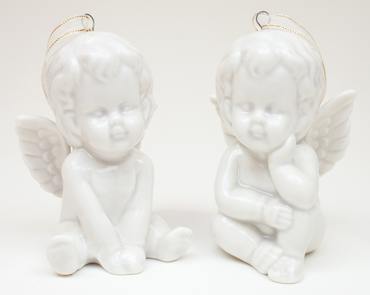 Porcelain angel white sitting 8x6x5cm 2 poses