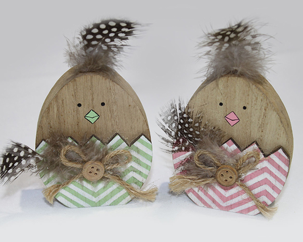 funny wooden chick with feather hair, bow and button